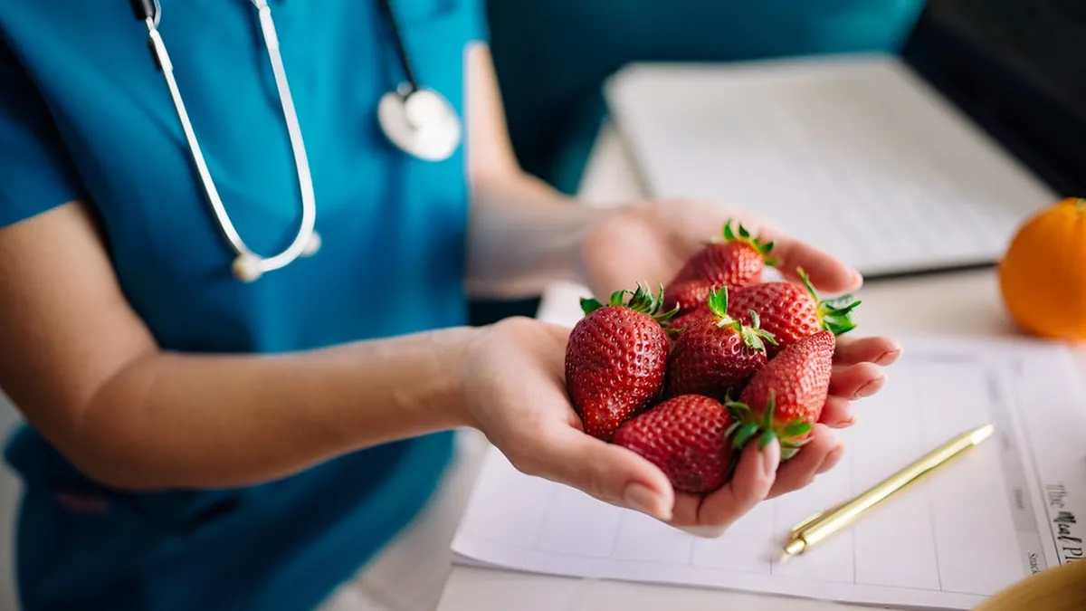 Nutritionist discussing a meal plan with a patient during cancer treatment