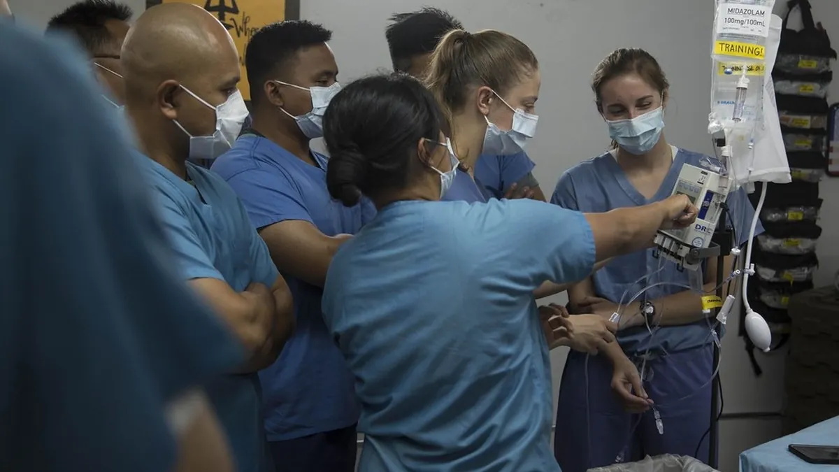 Nurses preparing an infusion pump for intravenous treatment