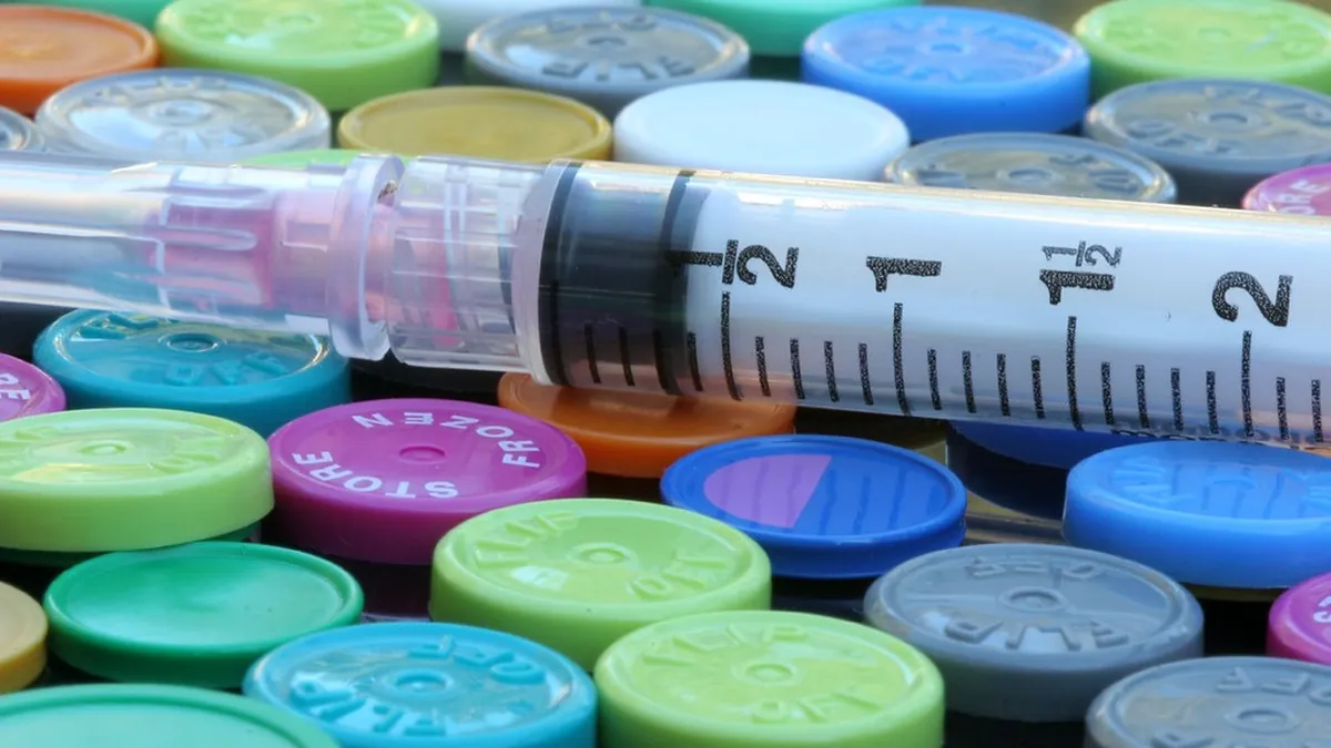 Syringe and medicine vials prepared for a patient-specific chemotherapy regimen